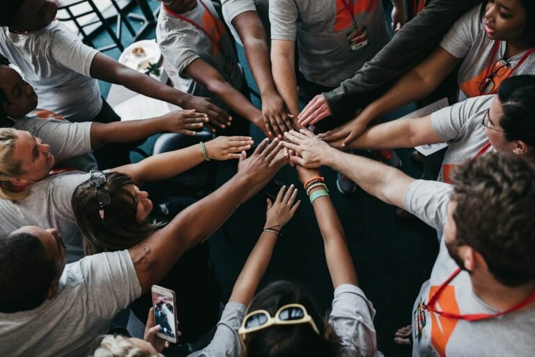 Community volunteers joining hands together